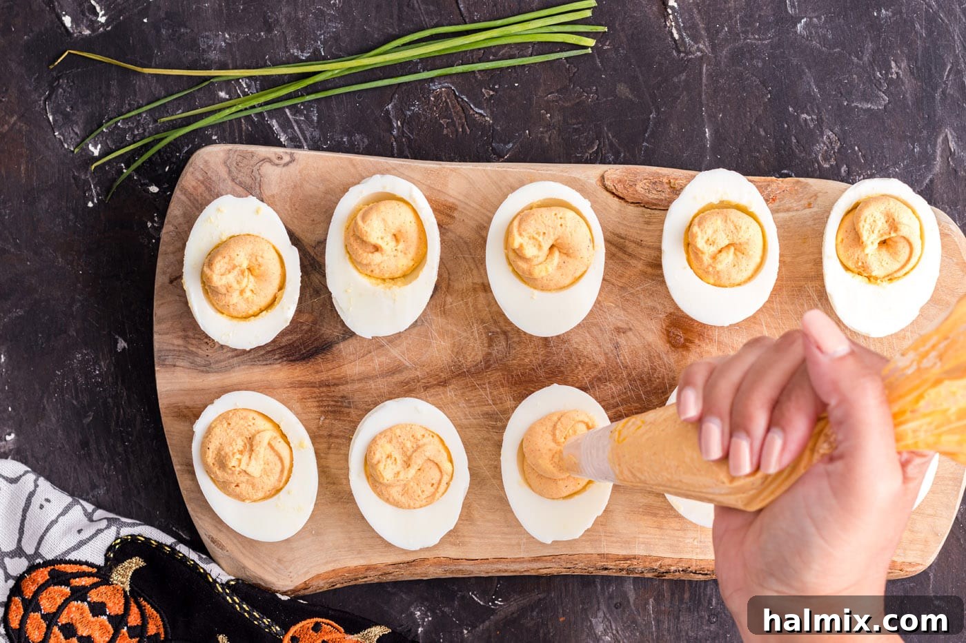 Spiced Pumpkin Deviled Bites 7 Piping eggs with yolk mixture into egg white halves