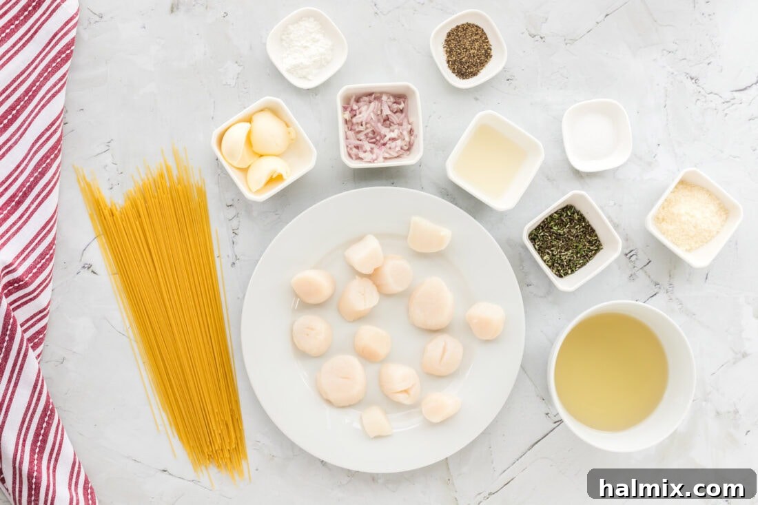 An overhead shot displaying all the fresh ingredients laid out for making Scallop Pasta