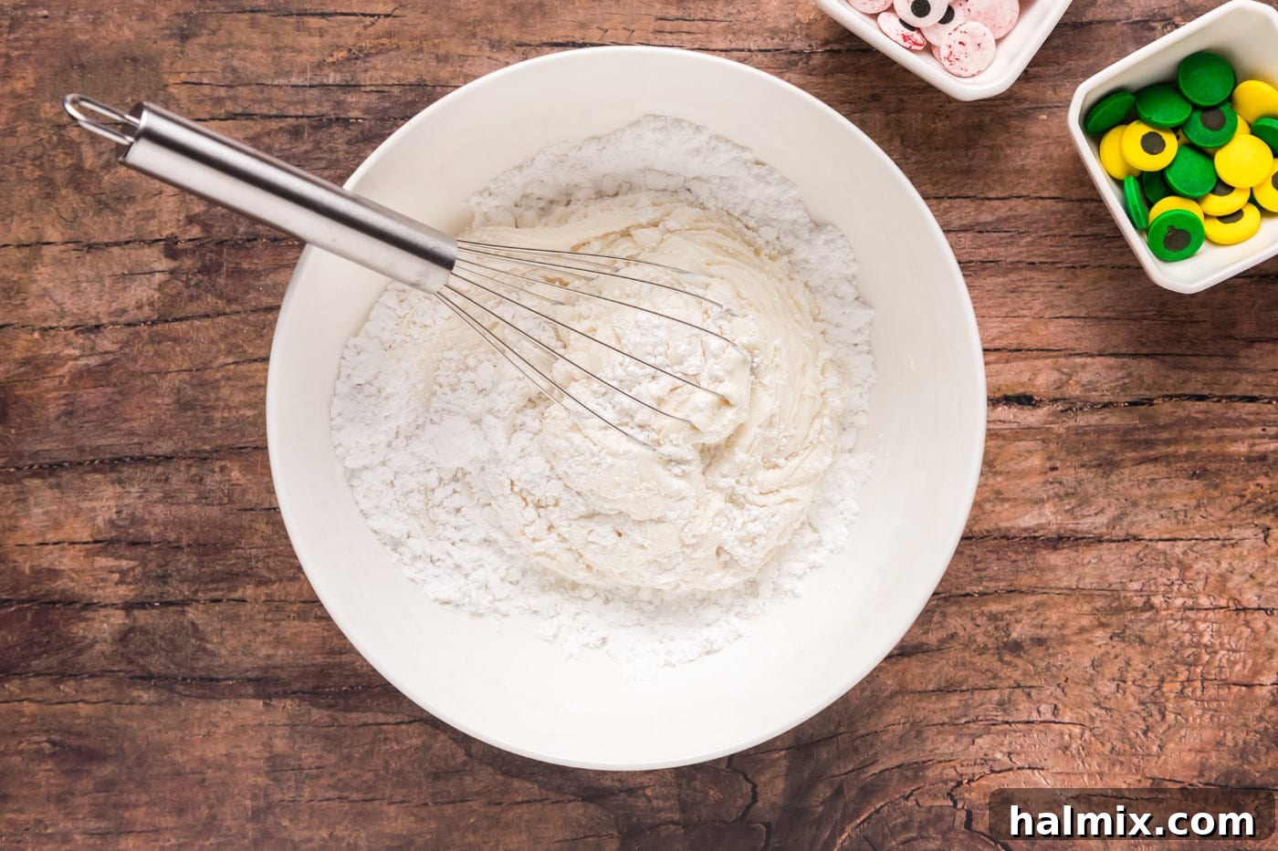 Whisking powdered sugar into canned vanilla frosting