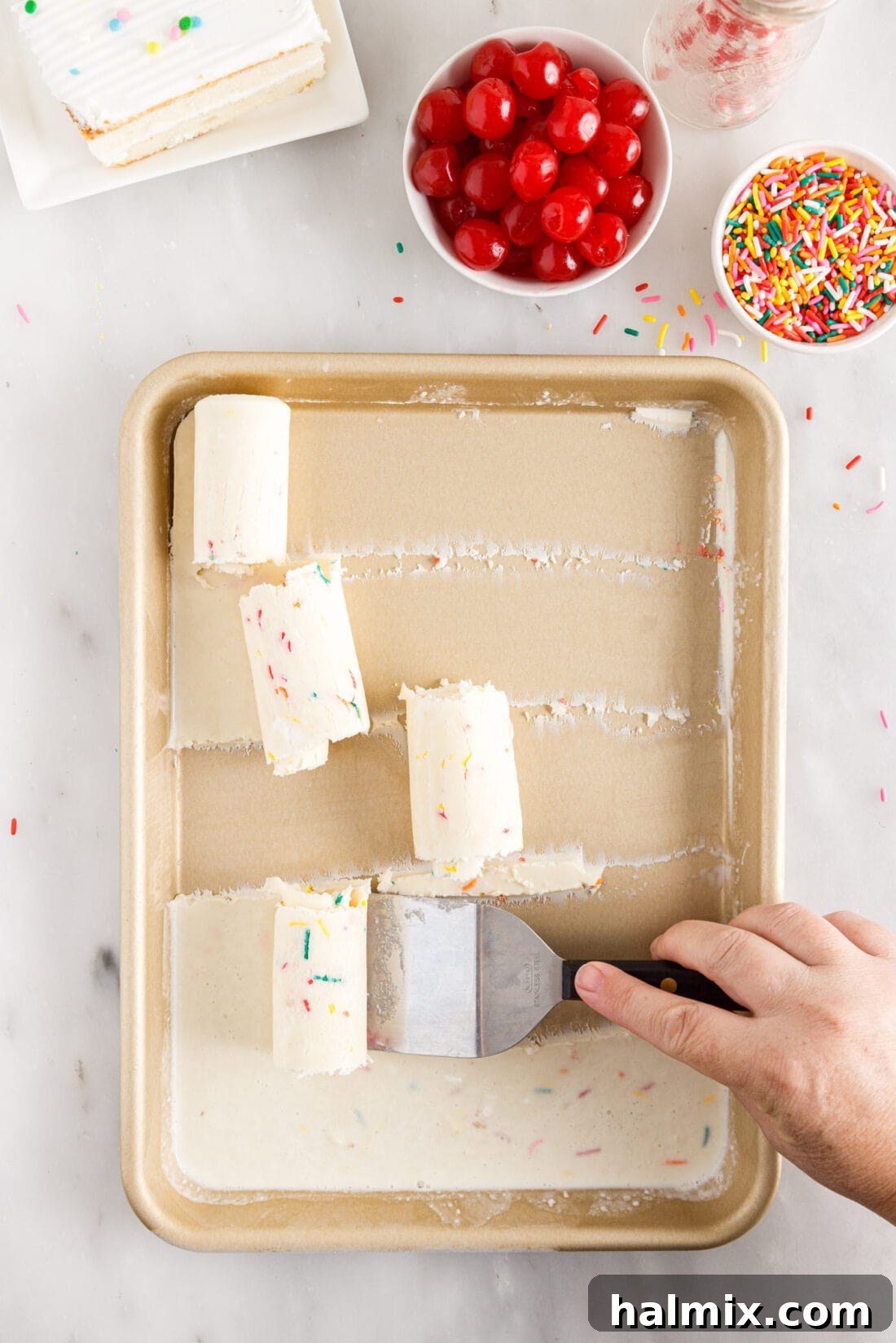 scraping Birthday Cake Rolled Ice Cream out of pan