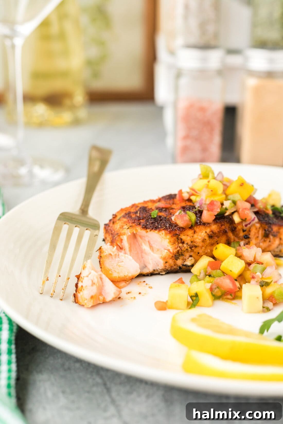 Cajun Seared Salmon 3 A fork holding a piece of perfectly cooked Blackened Salmon, showing its flaky texture.