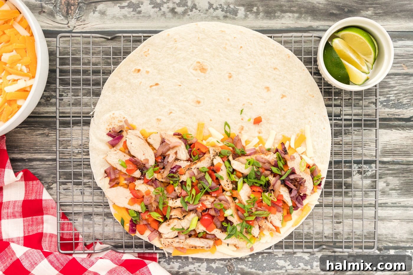 Chicken, bell pepper, onions, and cheese layered on a tortilla