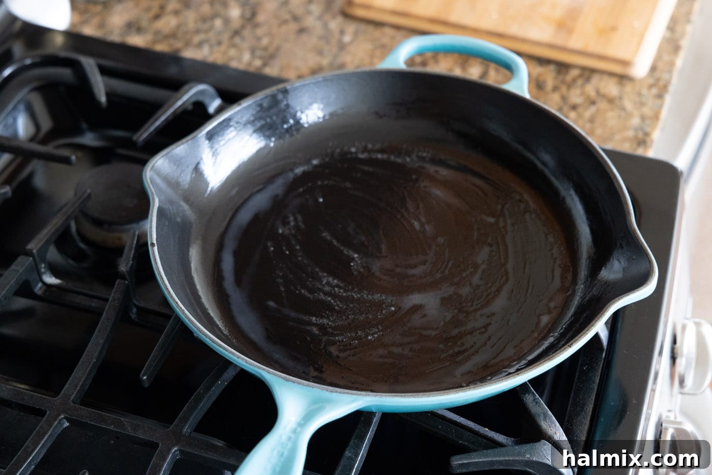 A buttered skillet heating on a stovetop