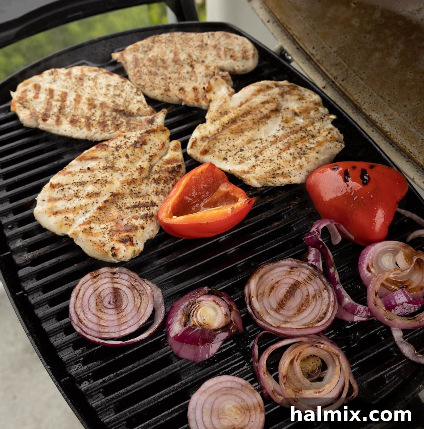 Chicken, bell pepper, and onion cooking on the grill