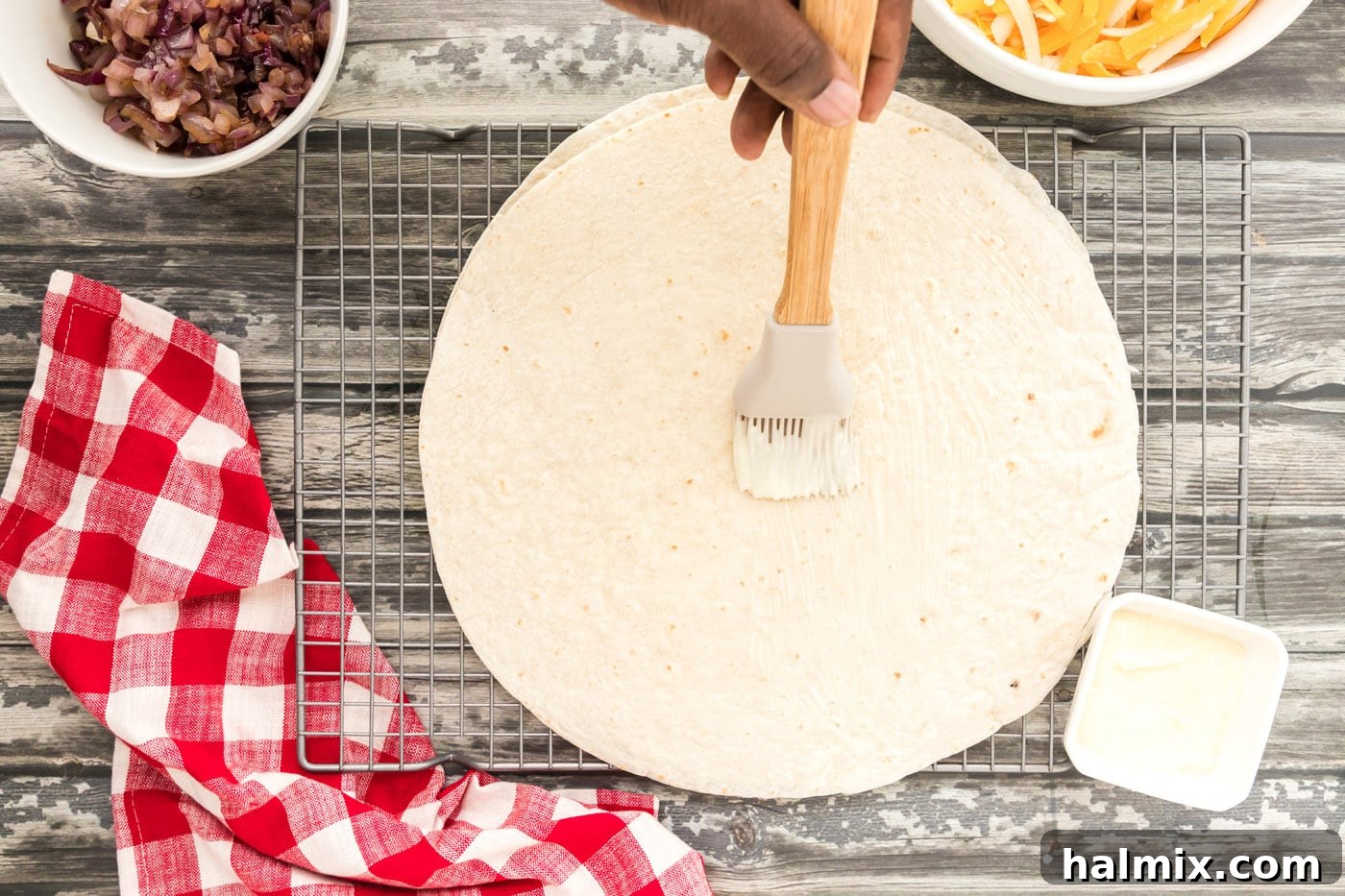 Brushing a tortilla with butter