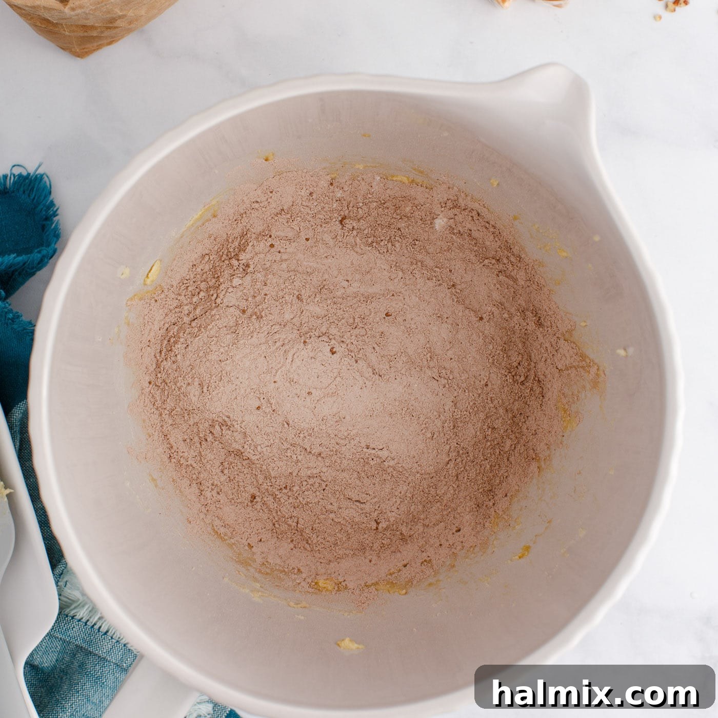 flour and cocoa powder added to mixer with butter and sugars