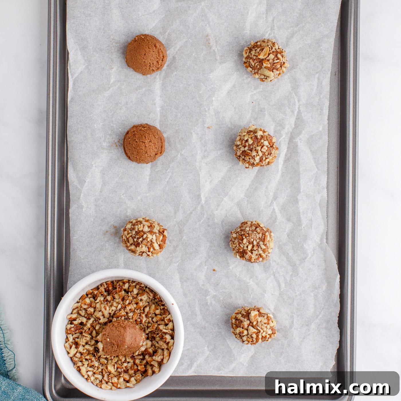 rolling turtle thumbprint cookies in pecans