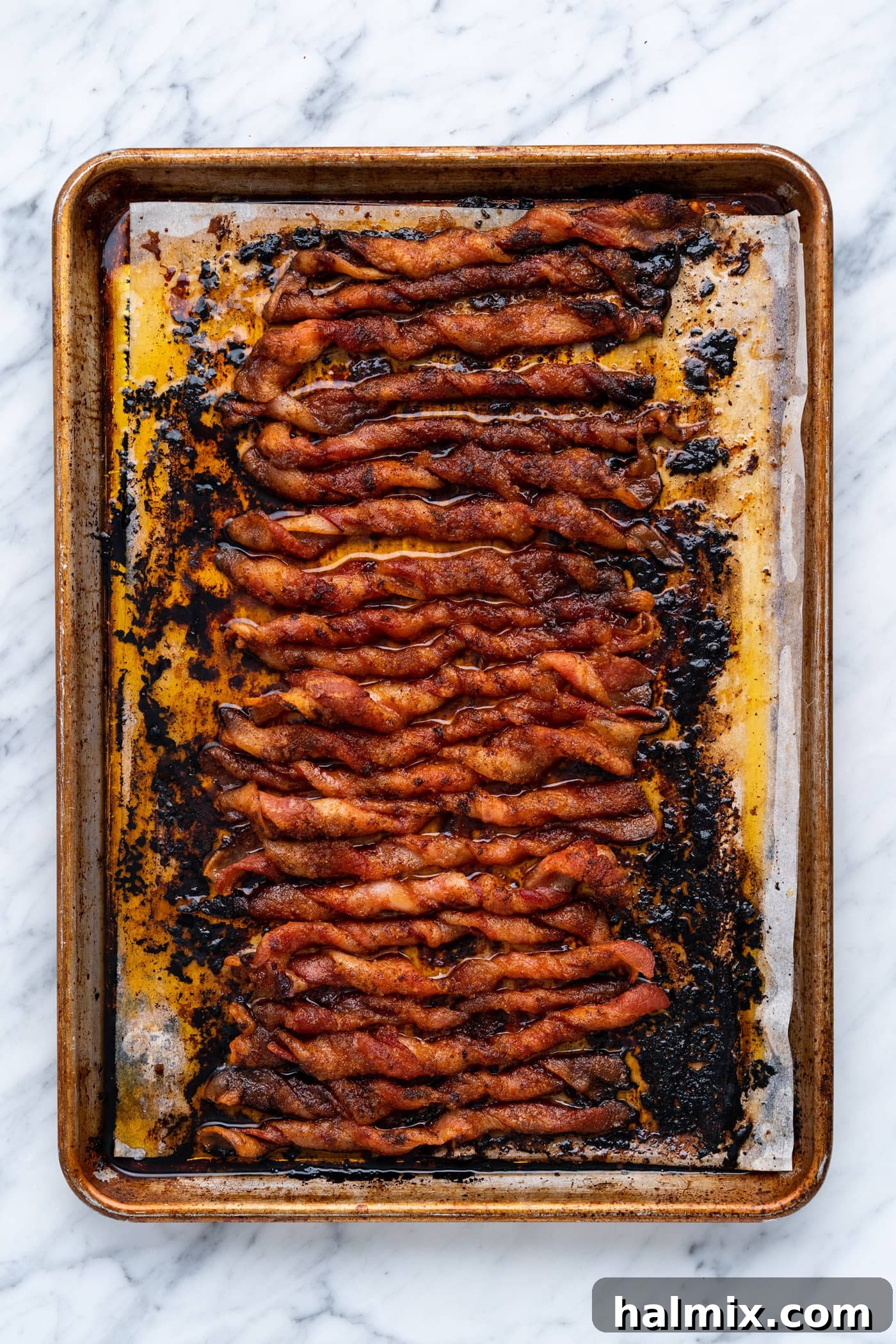 Caramelized Bacon Bites 9 Cooked bacon twists on a baking tray