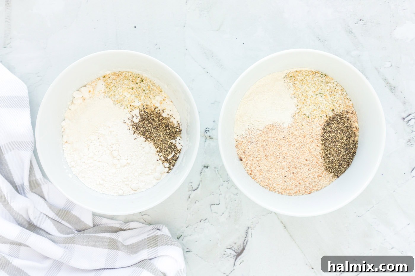 Three plates set up for dredging chicken: flour, egg wash, and seasoned breadcrumbs