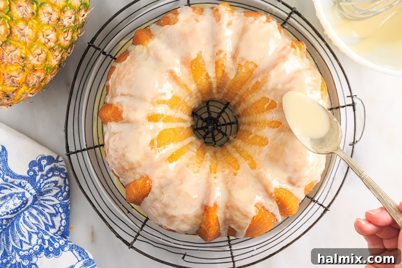 Luscious Pineapple Pound Cake 13 A generous stream of pineapple glaze being spooned over the cooled pineapple pound cake, creating an appetizing cascade.