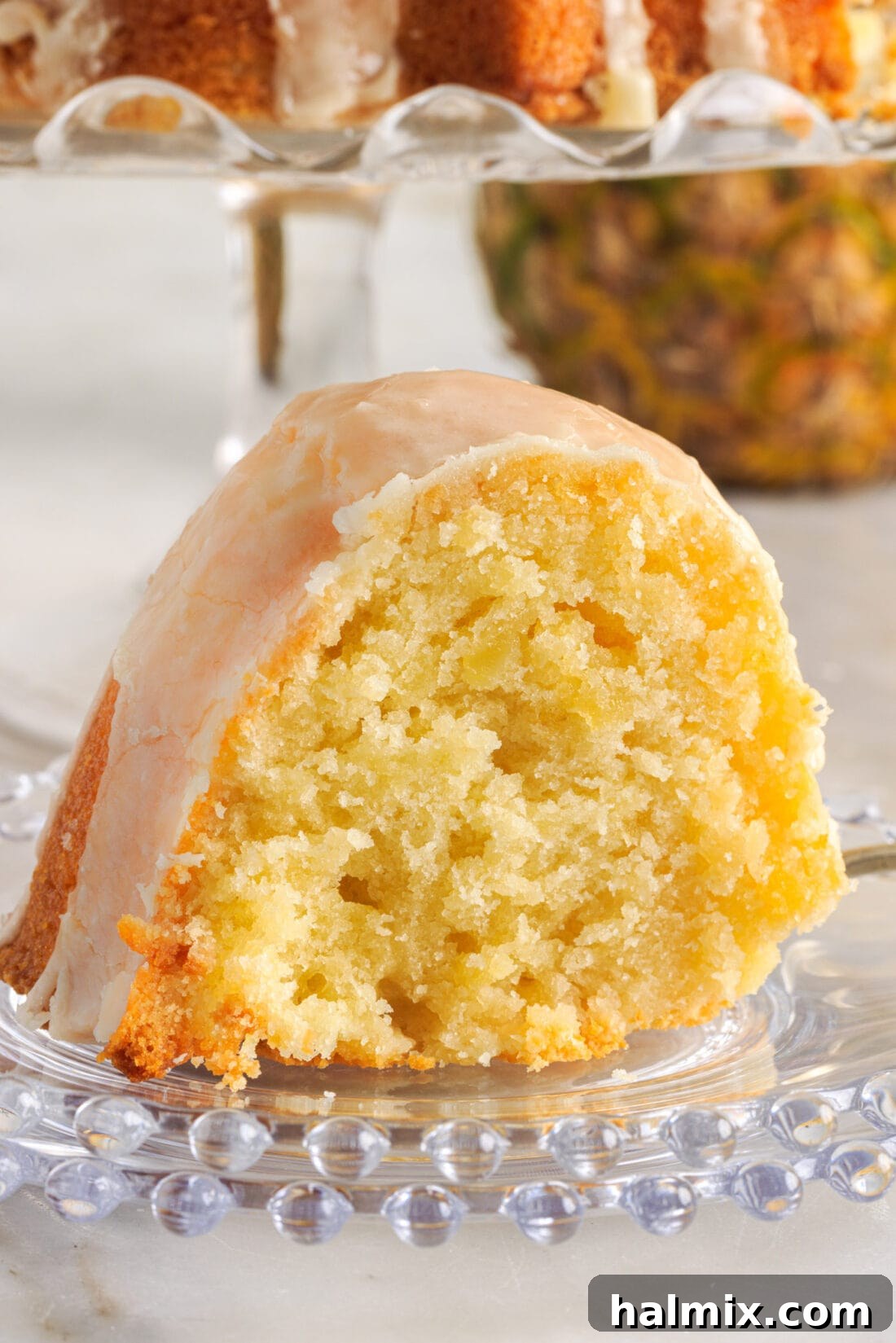 Luscious Pineapple Pound Cake 14 A perfectly portioned slice of Pineapple Pound Cake, showcasing its dense, moist texture and the glistening glaze, ready for enjoyment.