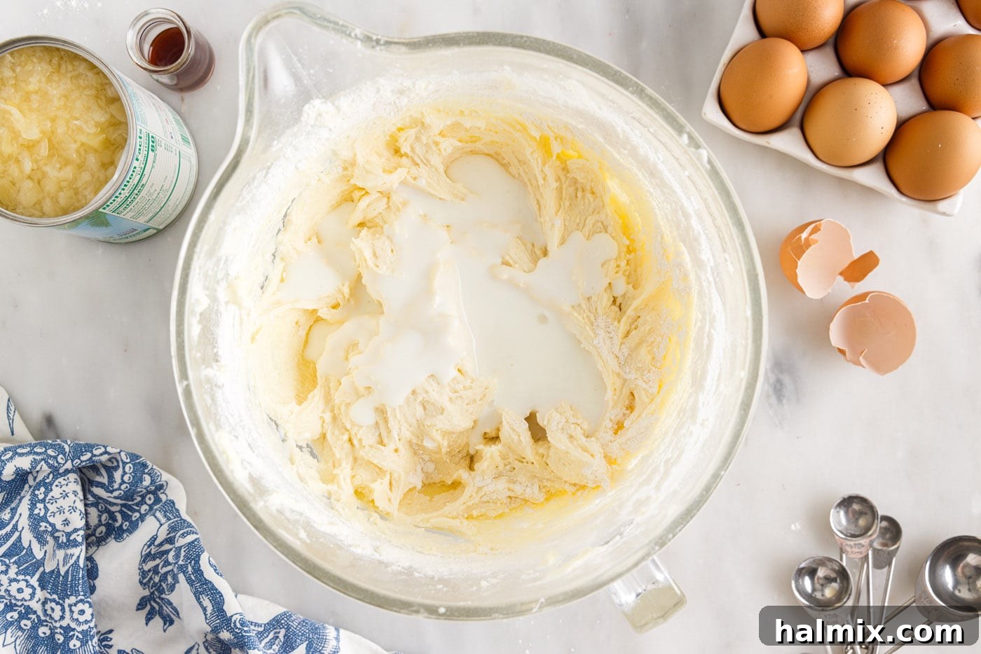 Luscious Pineapple Pound Cake 8 Buttermilk being poured into the pound cake batter, alternating with dry ingredients for a moist and tender crumb.