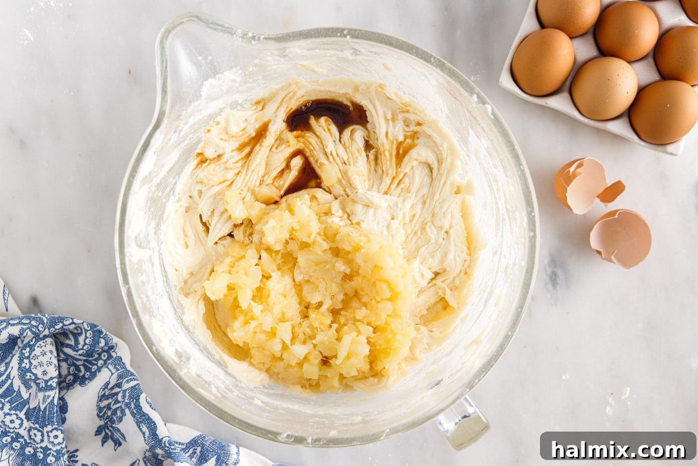 Luscious Pineapple Pound Cake 9 Crushed pineapple and vanilla extract added to the pound cake batter, ready to be gently mixed until evenly distributed.
