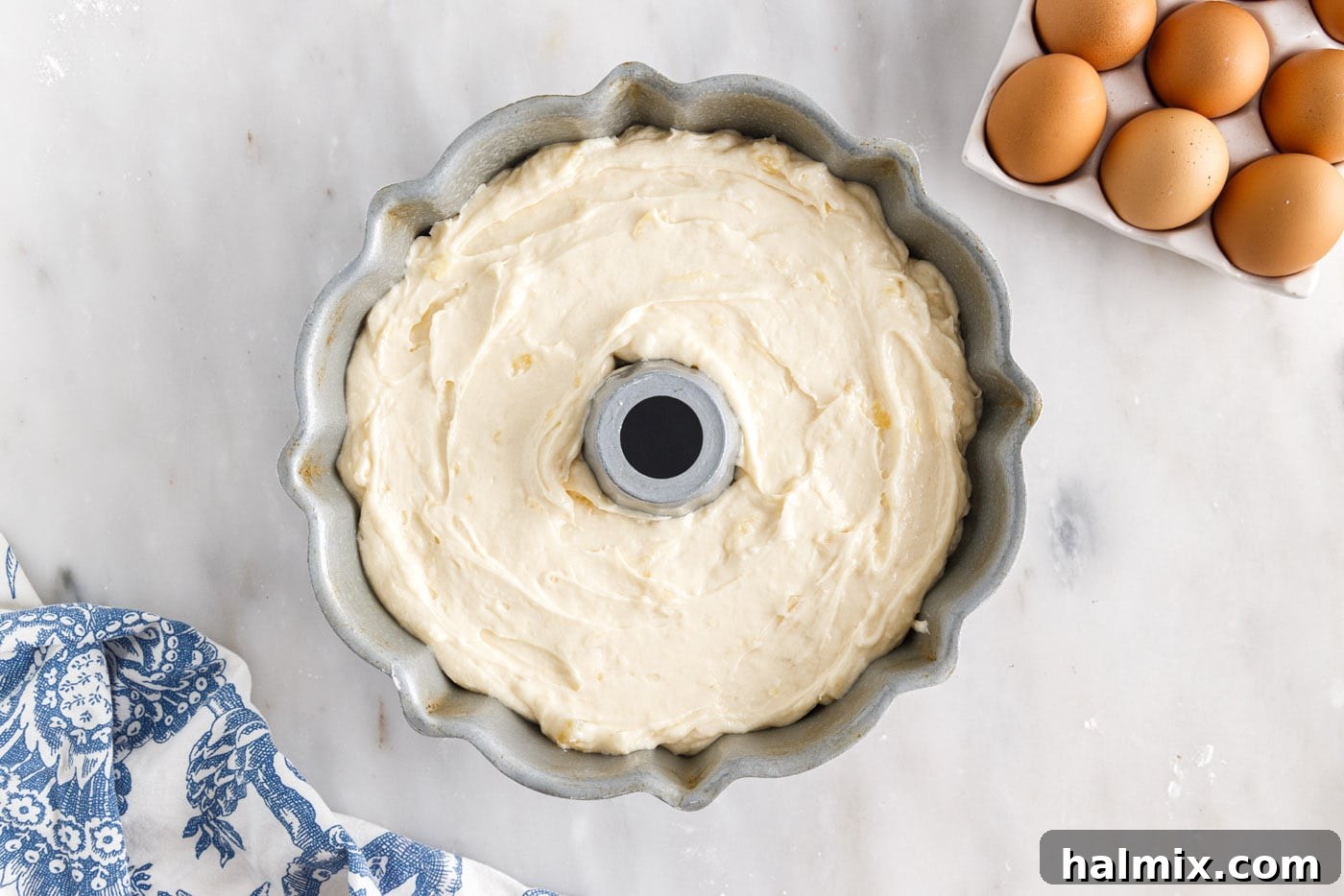 Luscious Pineapple Pound Cake 10 Pineapple pound cake batter evenly poured into a bundt pan, ready for baking to achieve a golden finish.
