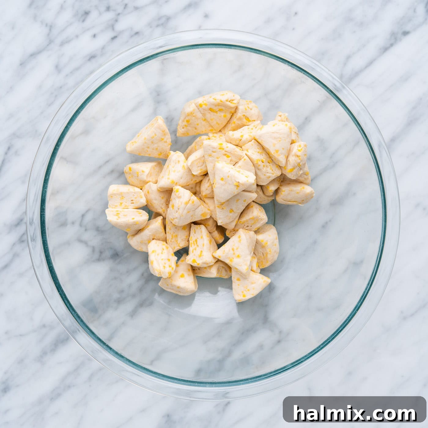 Pizza Zingers 5 Chopped biscuit dough in a bowl, coated with olive oil.