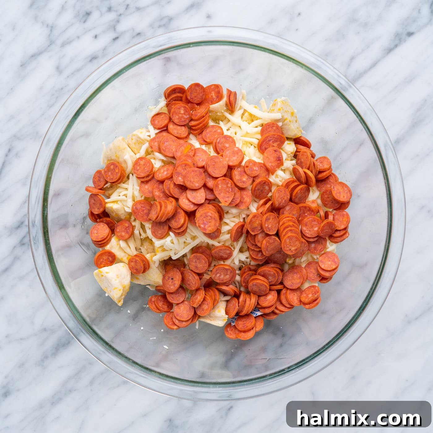 Pizza Zingers 7 Mini pepperonis, mozzarella cheese, and fresh basil added to the bowl with biscuit dough.