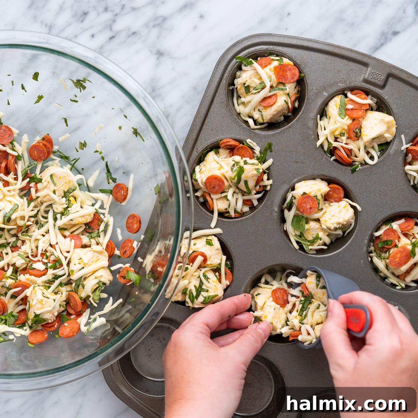 Adding the mixed pizza bite ingredients into the wells of a muffin pan.