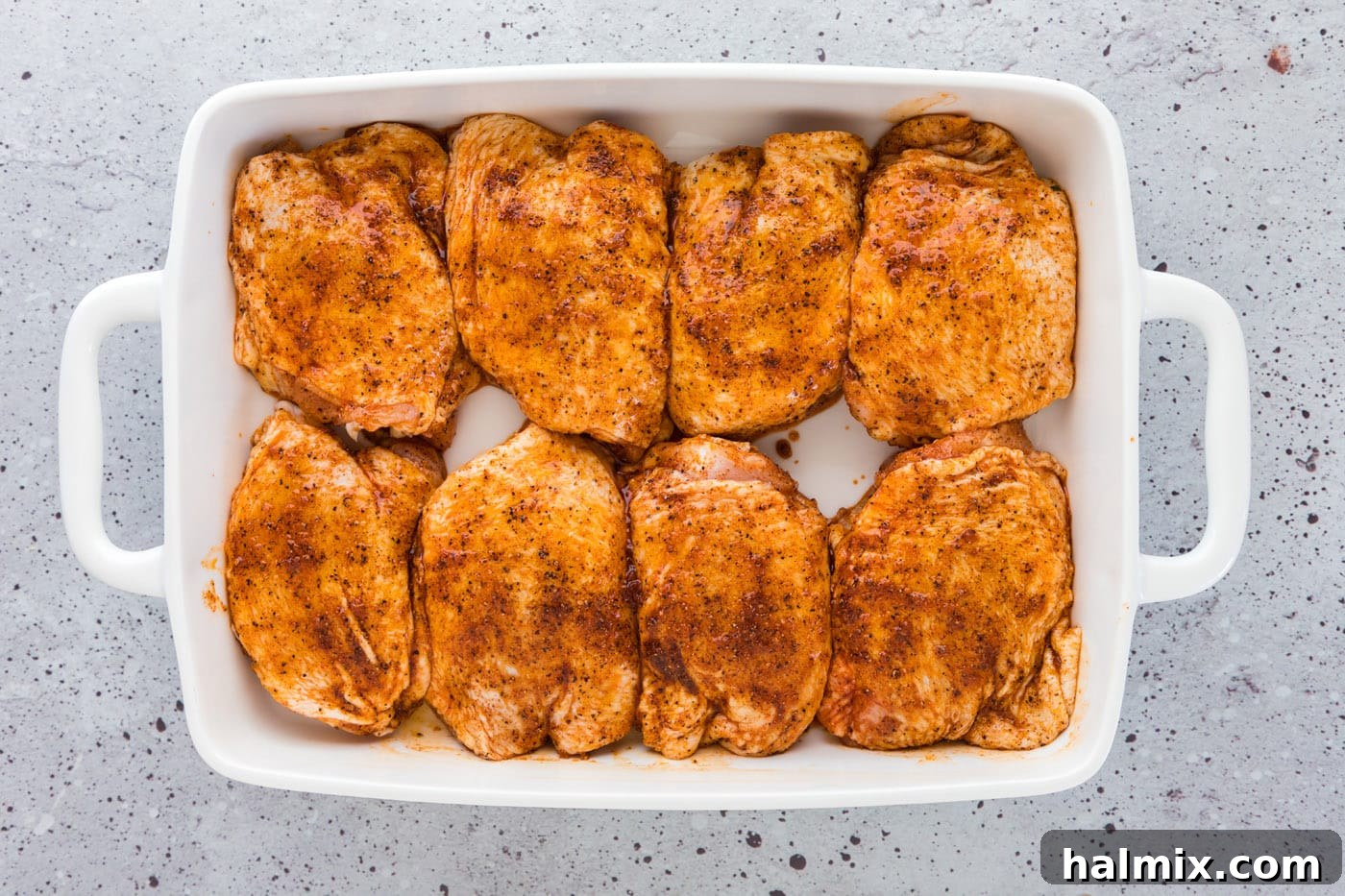 Crispy Golden Baked Chicken Thighs 7 seasoned chicken thighs in a baking dish