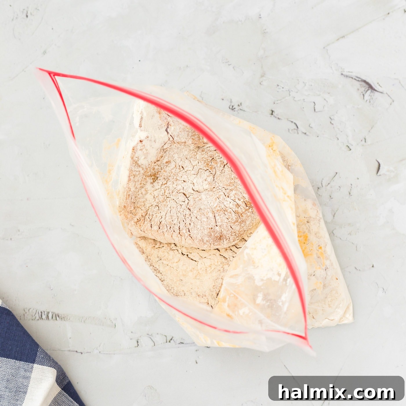 All-purpose flour in a gallon-sized ziplock bag, ready for coating pork chops