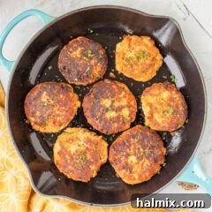 Salmon Croquettes in a skillet, showcasing their golden-brown color and inviting texture.