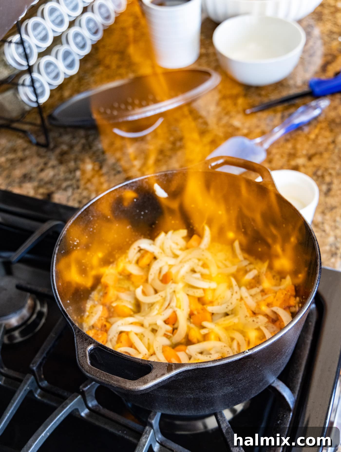 tall flames from flambéing Cognac in a dutch oven, demonstrating the height flames can reach