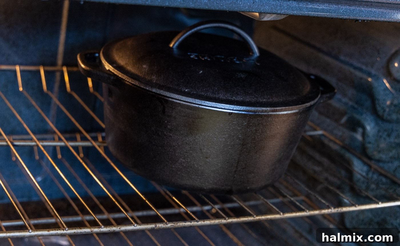 a covered dutch oven placed inside a preheated oven for slow braising