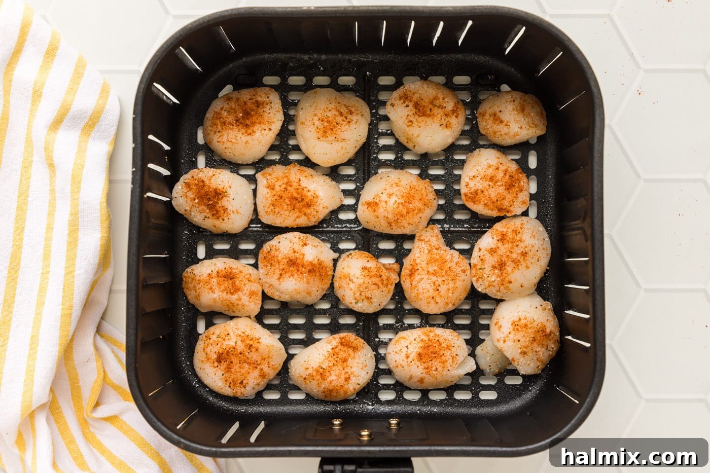 Scallops perfectly arranged in a single layer inside the air fryer basket