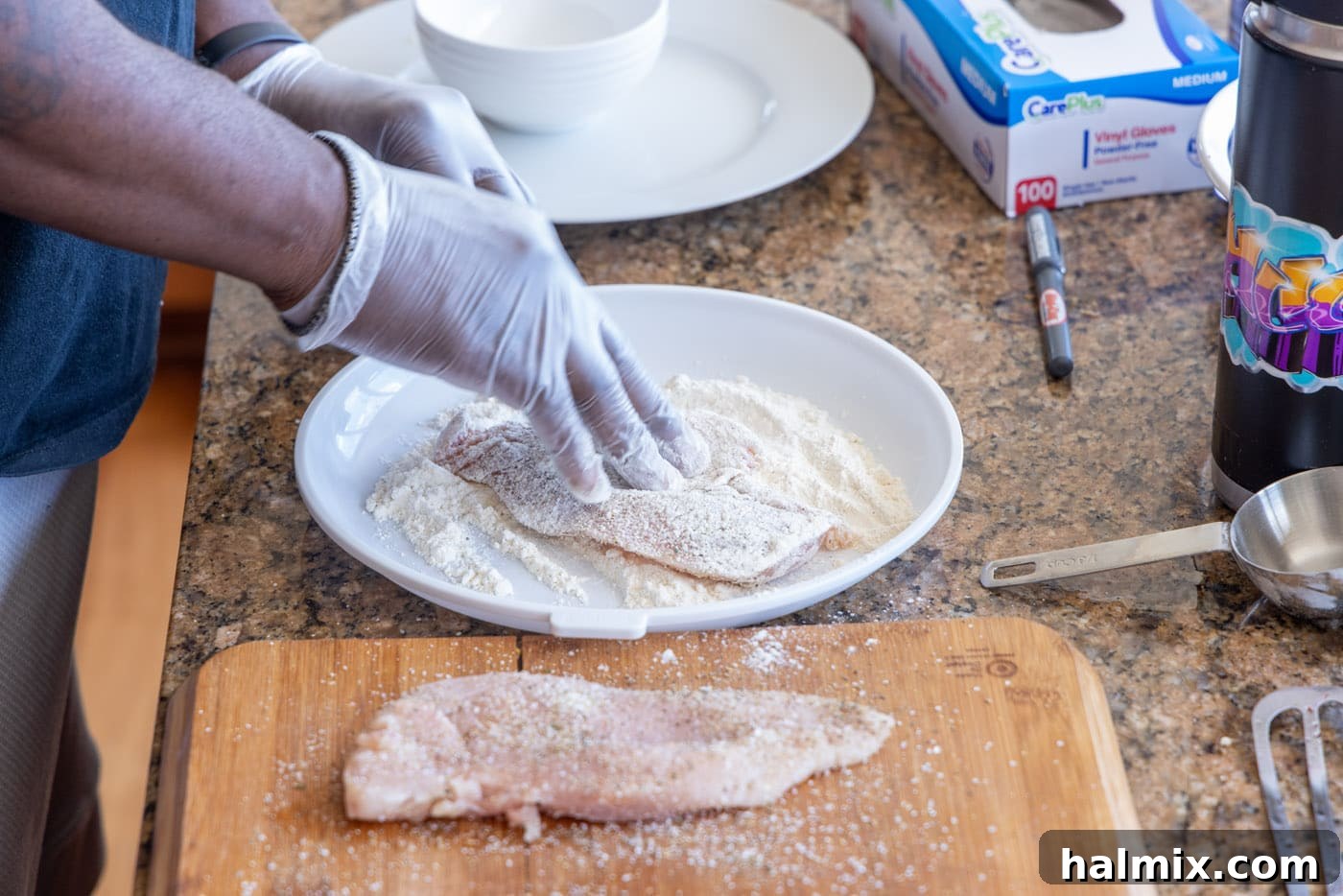Floured chicken breast ready for the skillet.