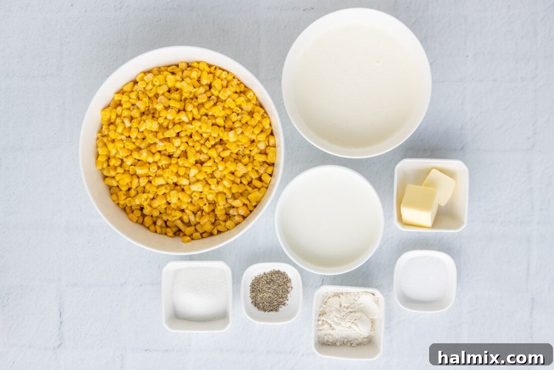 A selection of fresh ingredients laid out on a wooden surface, including corn, butter, milk, and cream, for making homemade creamed corn.