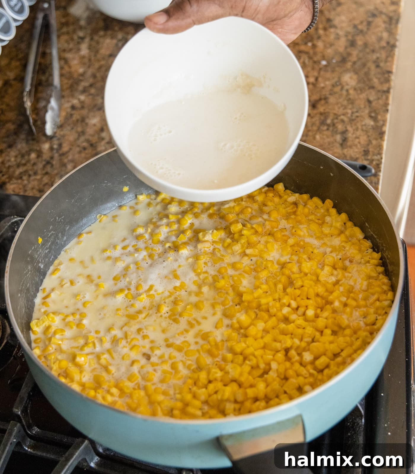 adding milk and flour mixture to the creamed corn in a skillet