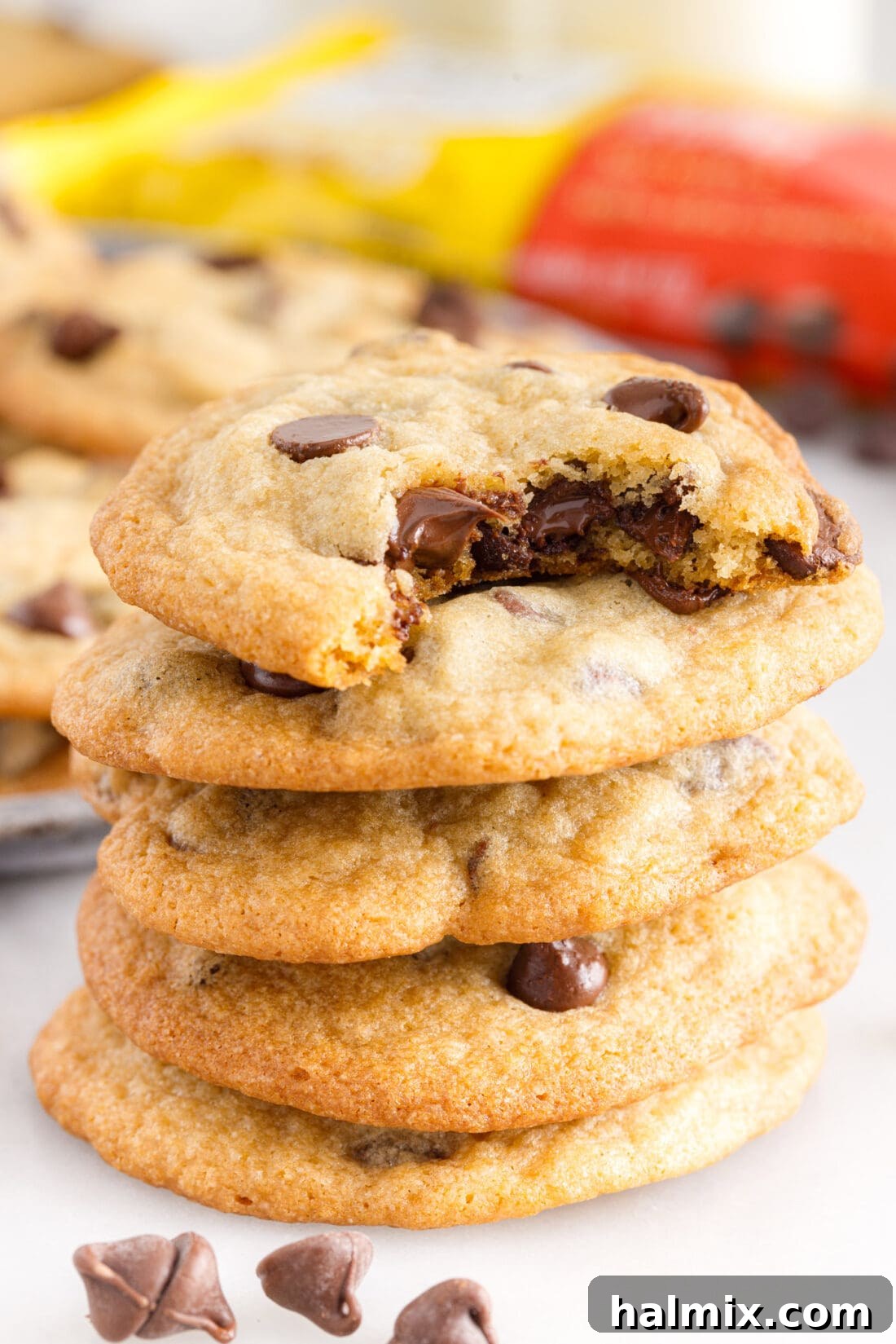 stack of nestle tollhouse chocolate chip cookies with a glass of milk