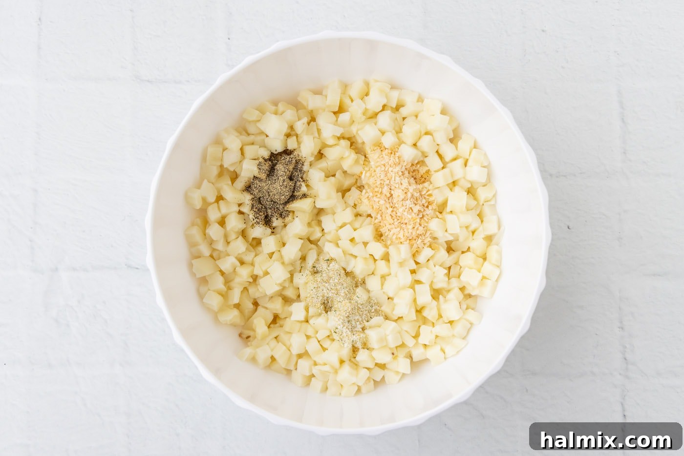 Comfort Potato Bake 6 diced potatoes with seasonings in a bowl