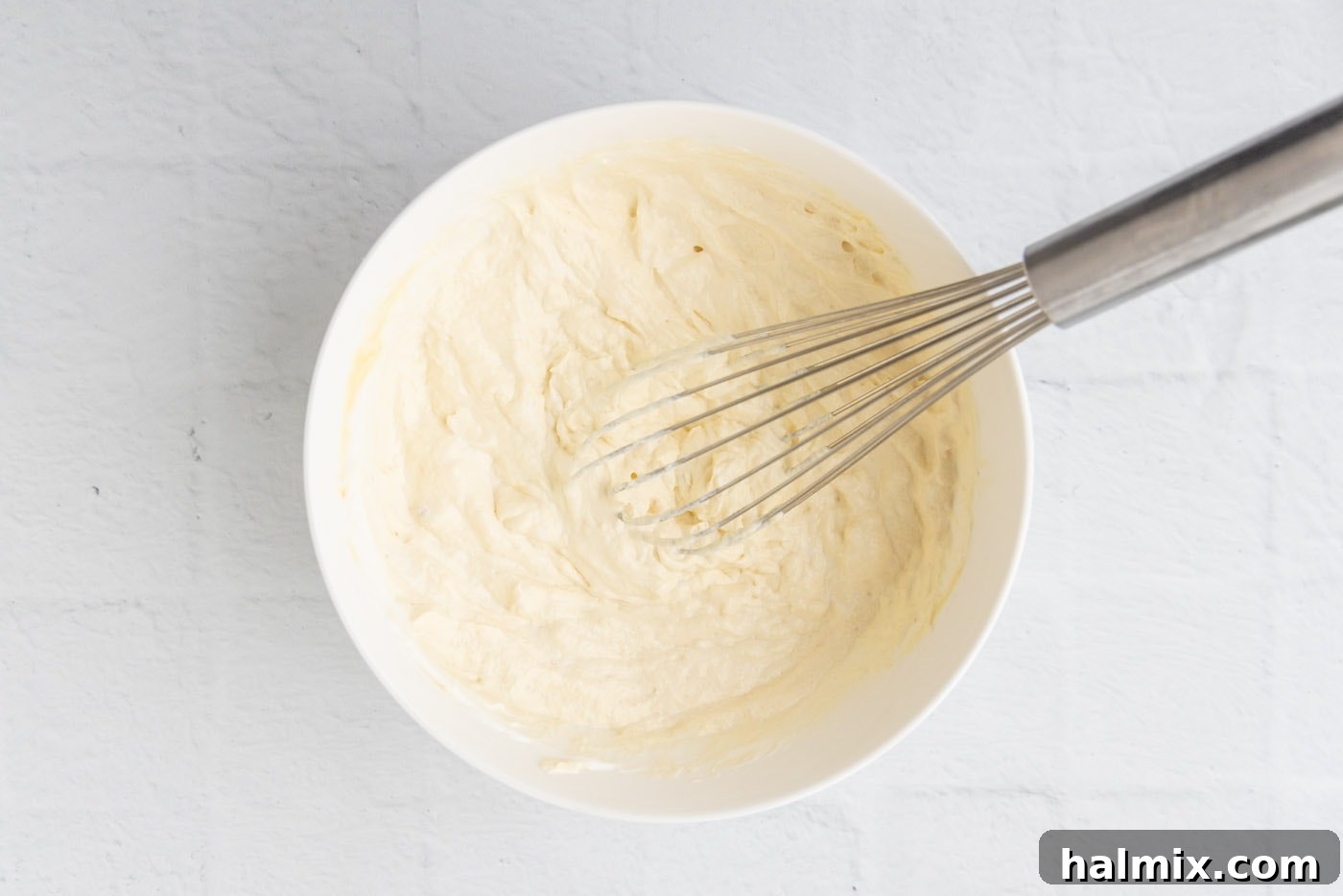 Comfort Potato Bake 9 whisked cream of chicken soup and sour cream in a bowl