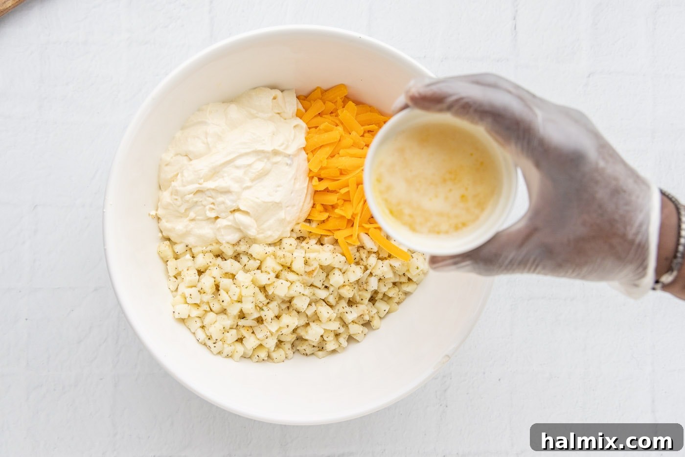 Comfort Potato Bake 10 potatoes, cream of chicken mixture, and cheese in a bowl