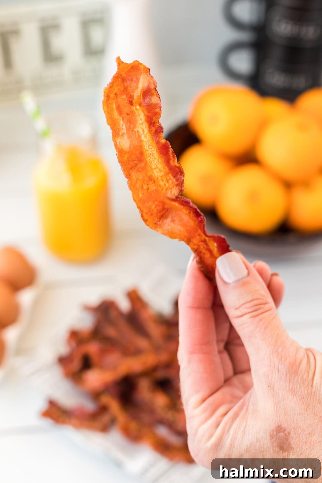 Crispy oven-baked bacon being held