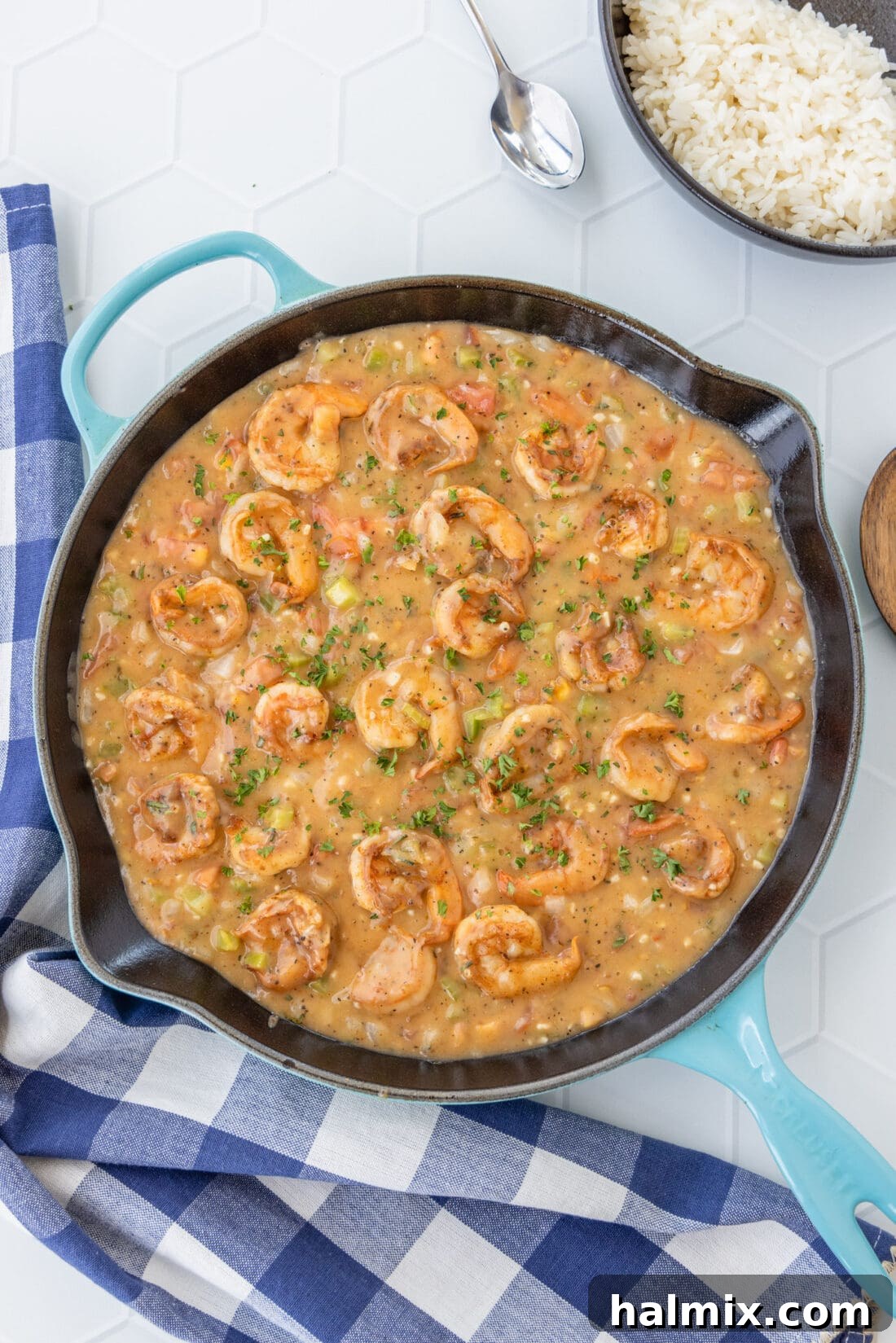 Shrimp Etouffee in a skillet, garnished with fresh herbs, ready to be served.
