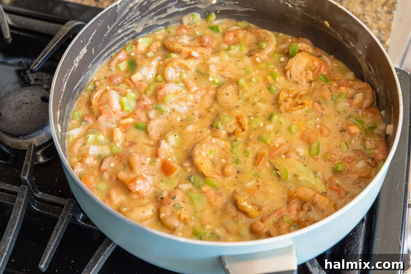 The finished Shrimp Etouffee simmering in a skillet, rich and flavorful.