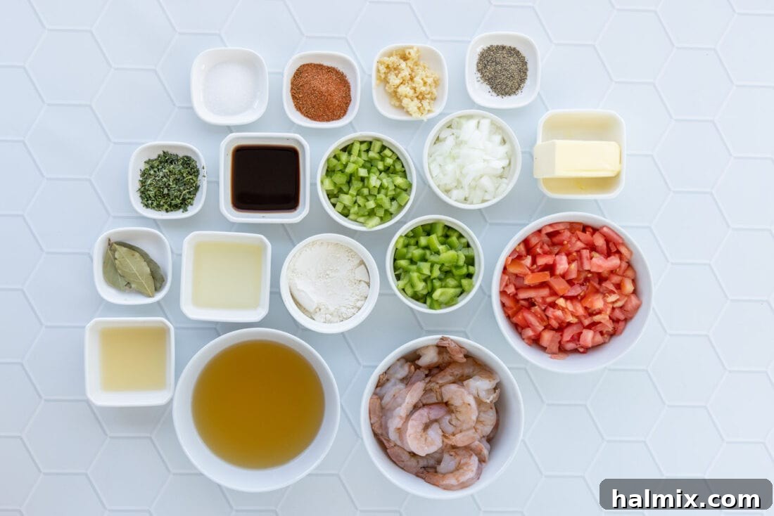 A collection of fresh ingredients laid out for making Shrimp Etouffee, including shrimp, vegetables, and spices.