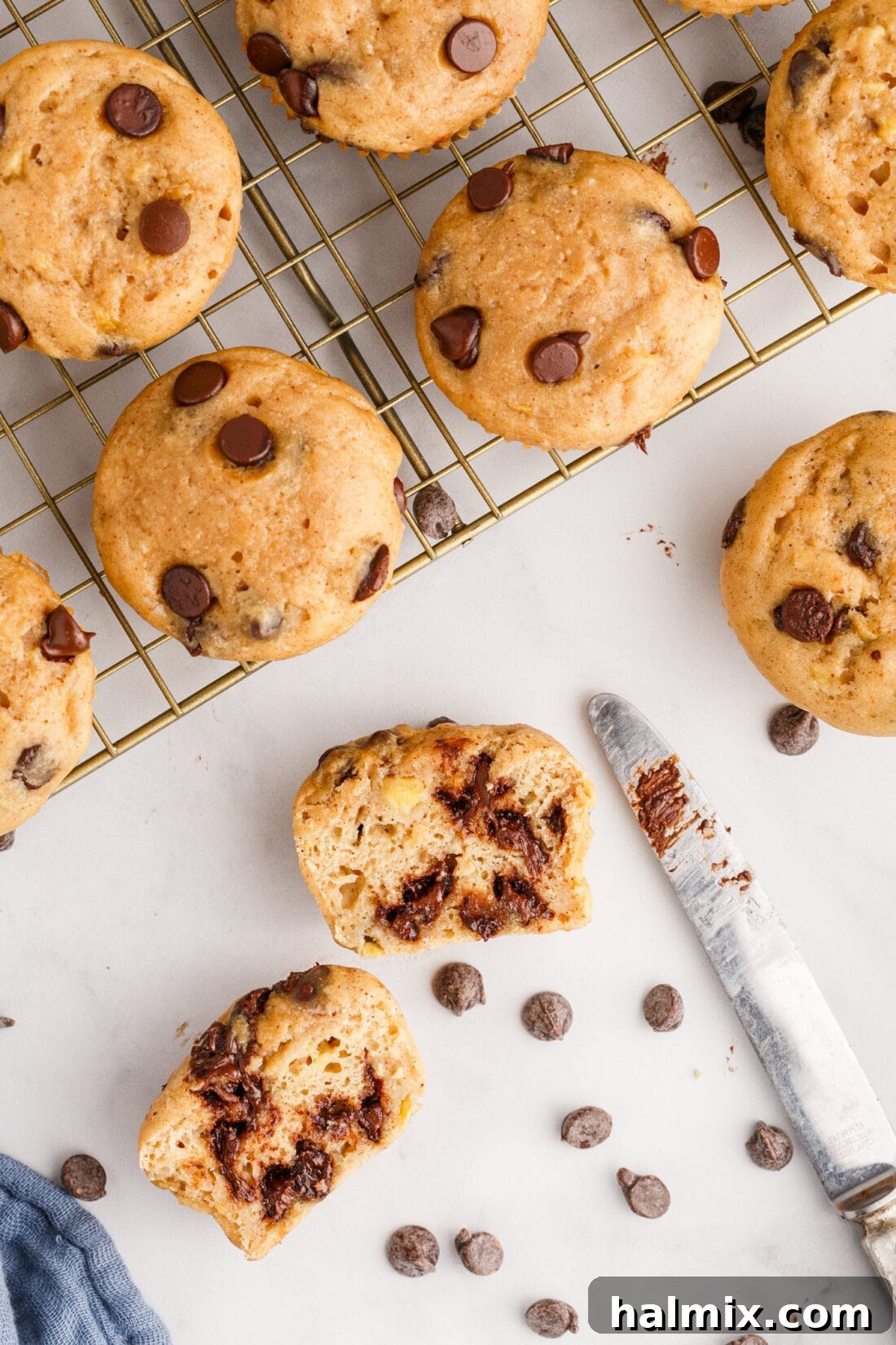 Chocolate Chip Banana Muffins on a wire rack with one cut open