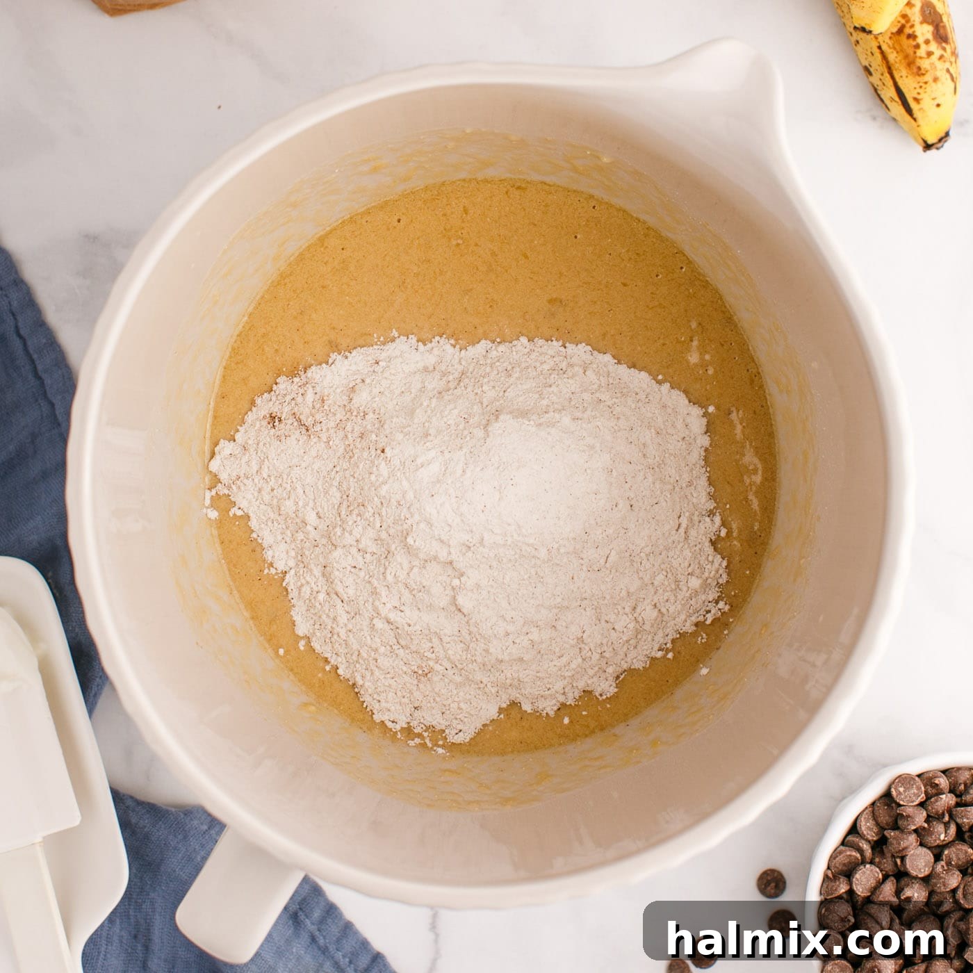 adding flour to muffin batter