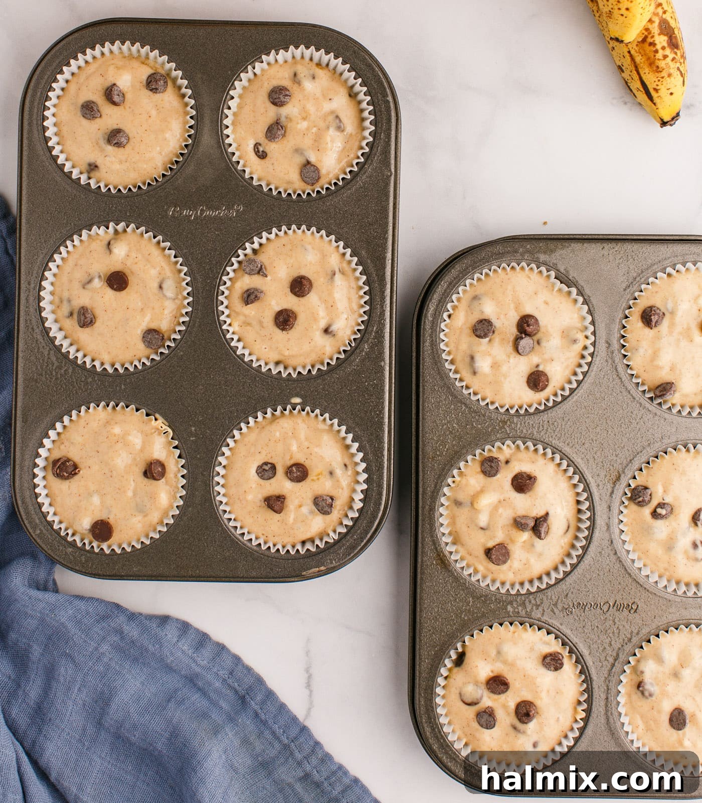 chocolate chip banana muffin batter in muffin trays