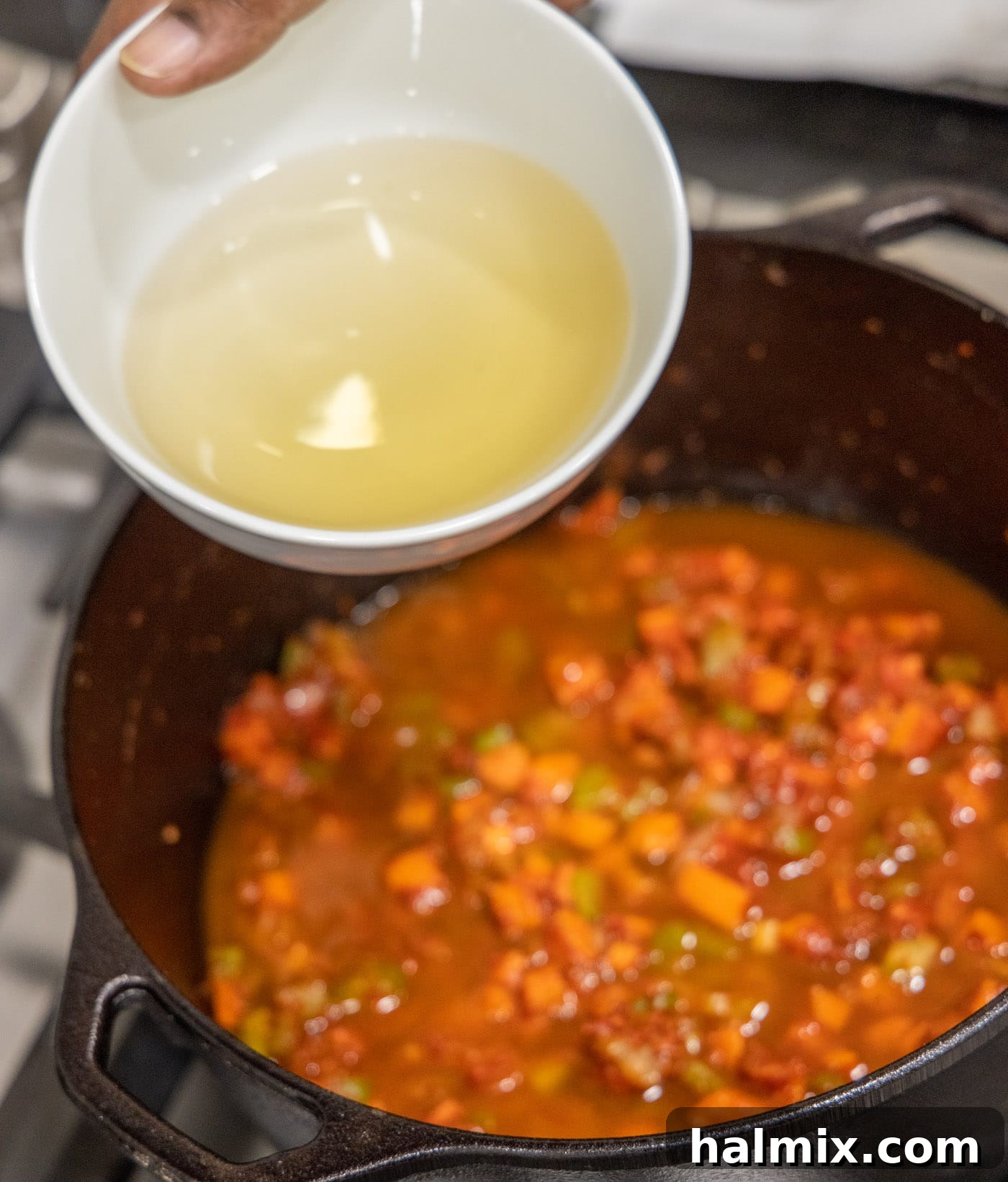 Meltingly Tender Veal Osso Buco 12 adding white wine to veal osso buco in dutch oven