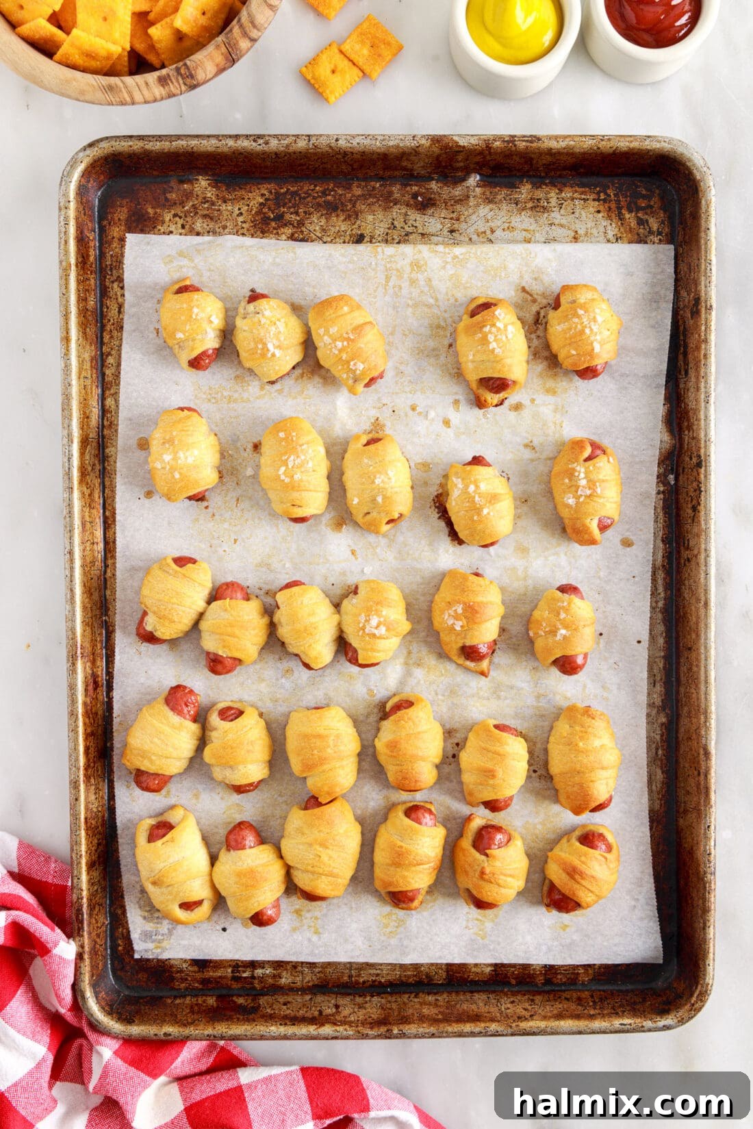 Sausage Swaddles 11 A baking pan filled with freshly baked, golden-brown Pigs in a Blanket.