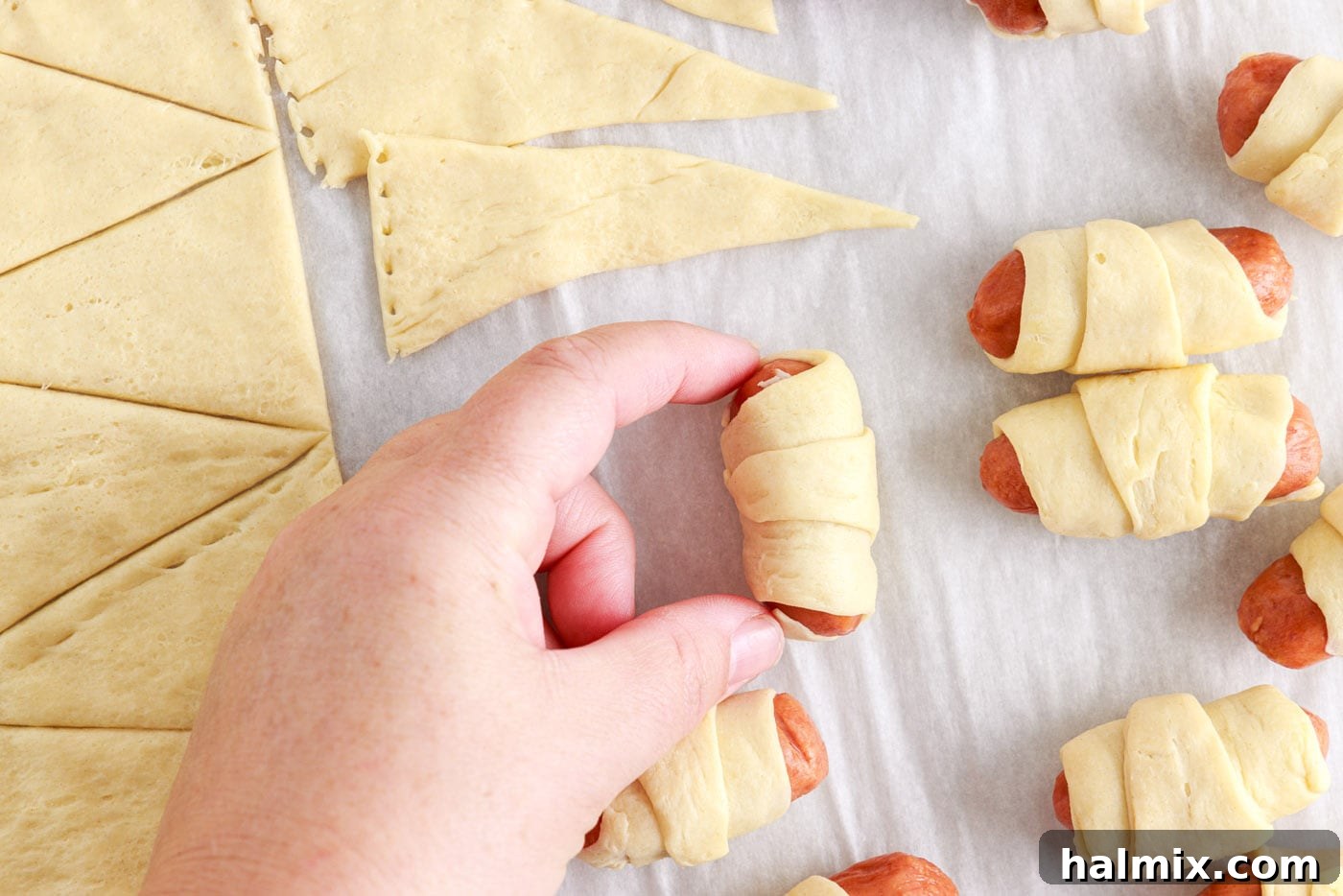 Sausage Swaddles 8 Finished mini crescent dogs neatly arranged on a baking sheet, ready for butter and salt.