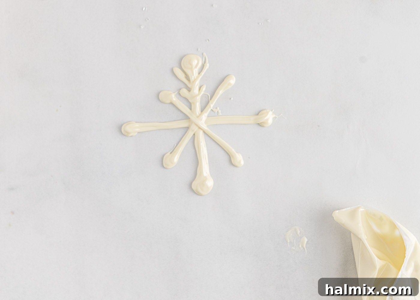 Step-by-step image of how to make white chocolate snowflakes