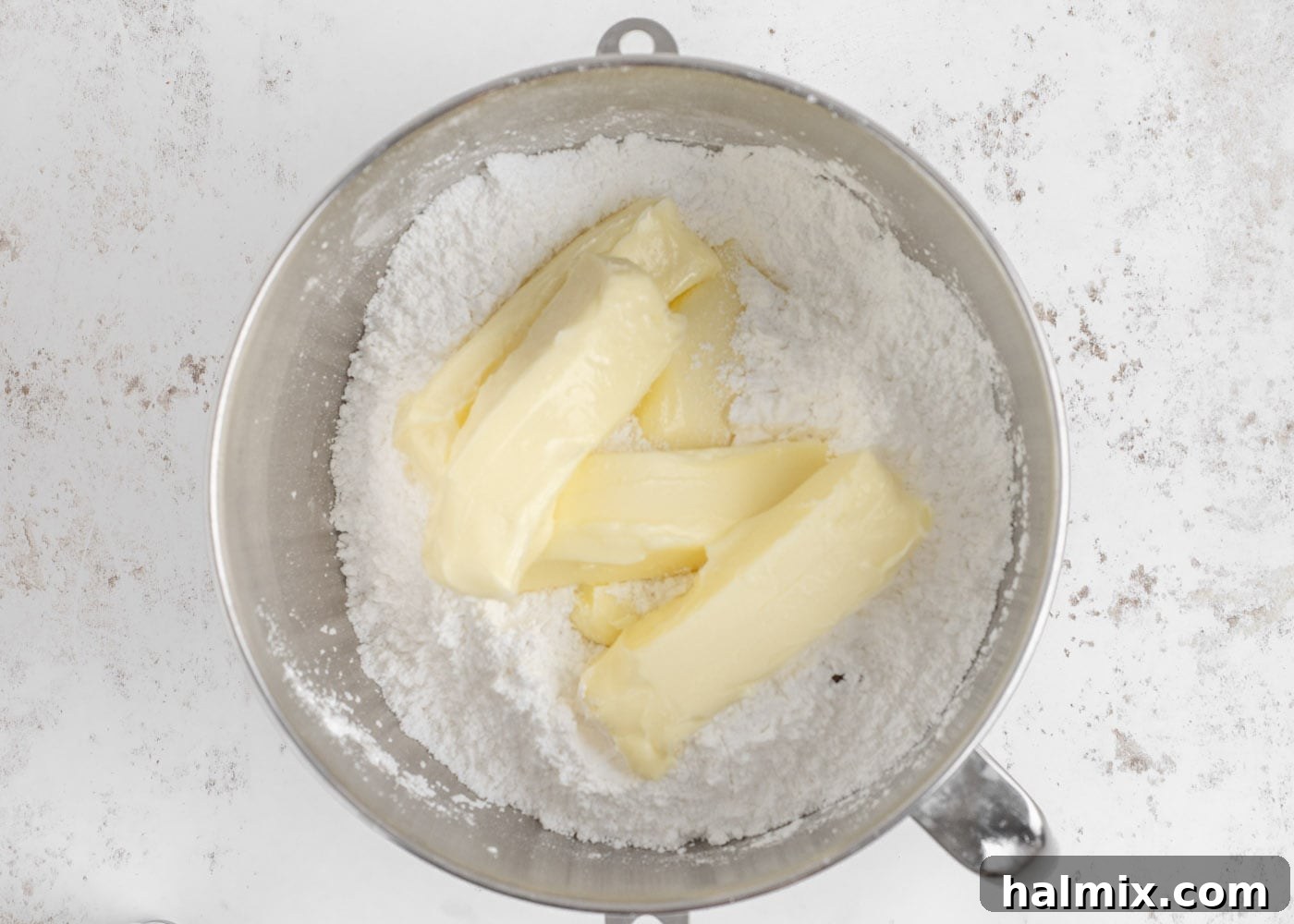 Butter and powdered sugar in a stand mixer bowl for frosting