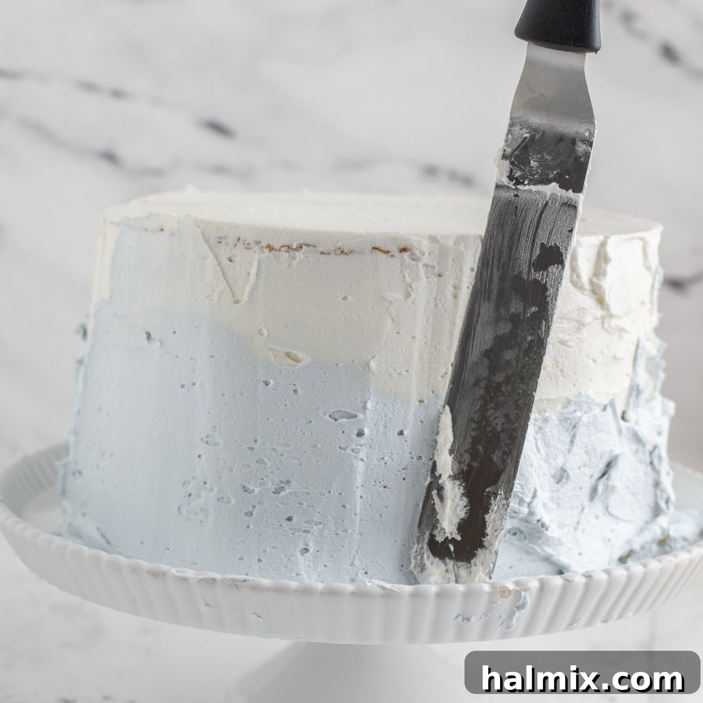 Tiered cake frosted with beautiful ombre colors