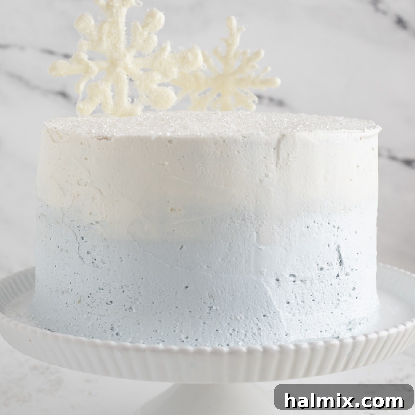 White chocolate snowflakes added to the top of a tiered cake for decoration