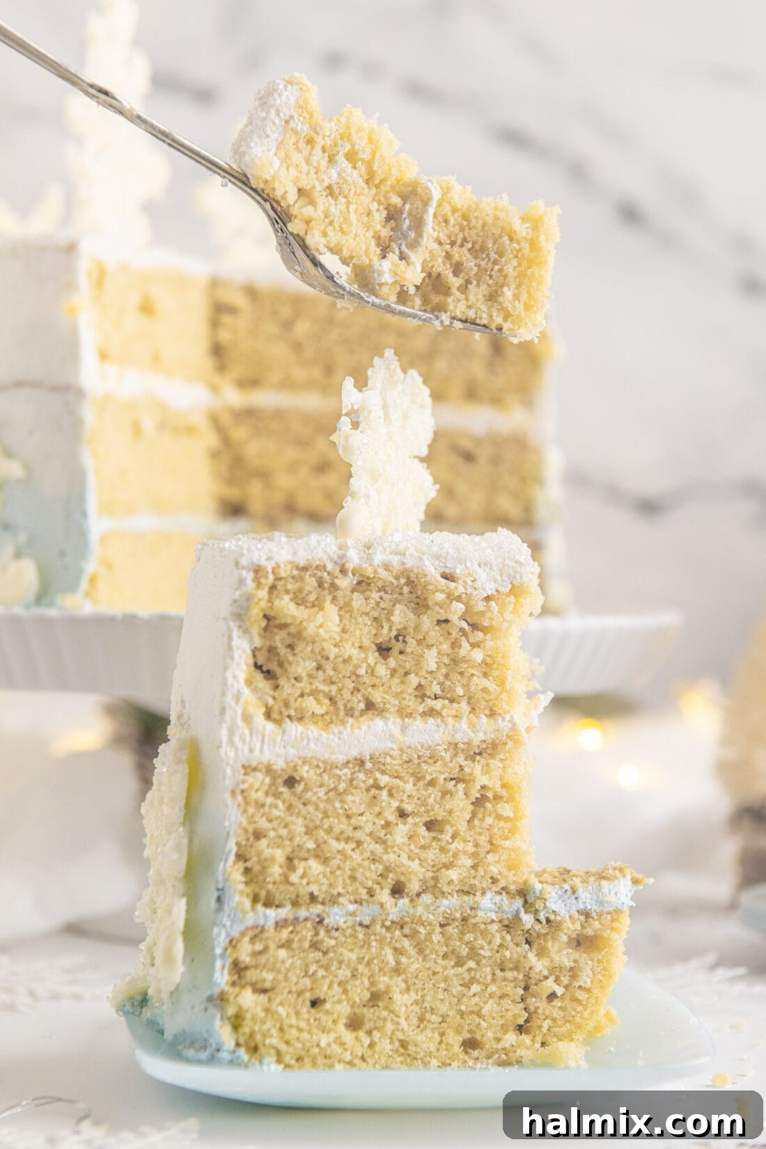 A perfectly sliced piece of Snowflake Cake on a plate
