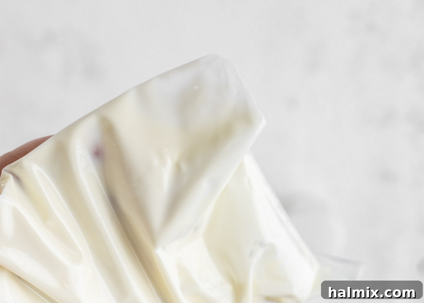 Melted white chocolate on a spatula, ready for piping